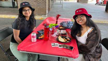 Students eating at the Summer BBQ event