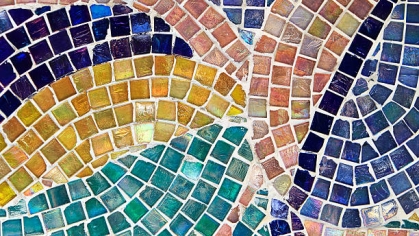 A colorful rainbow mosaic crafted into a swirl pattern.