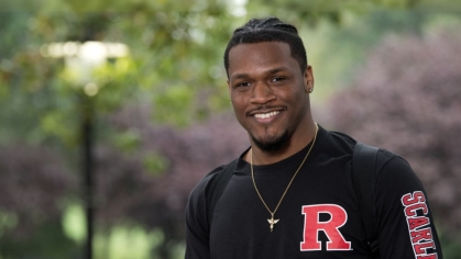 Student smiling while on Rutgers campus during summer