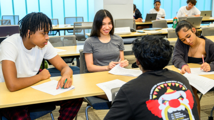 Students sitting at table writting