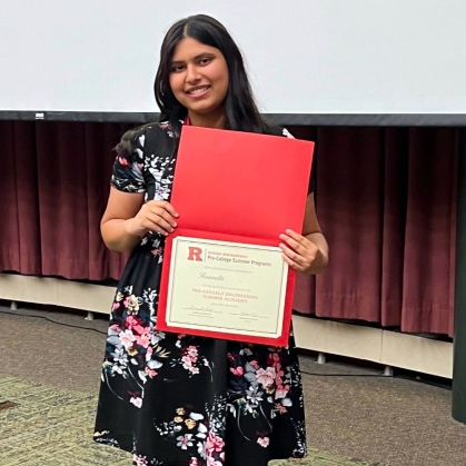 Pre-college student with their program certificate