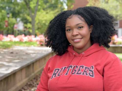 Rutgers student smiling outside on campus during summer