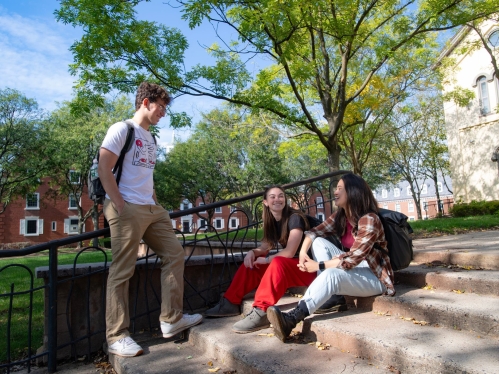 Students talking on campus during the summer