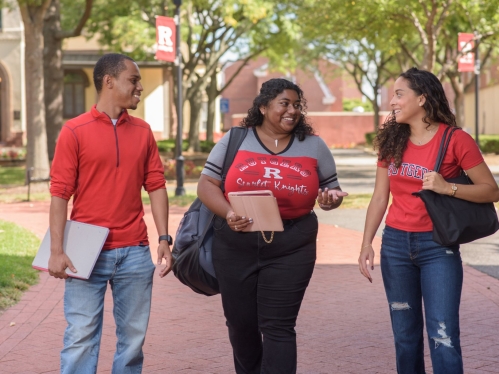 Rutgers students talking and walking together across campus