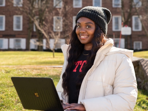 Student sitting outside on her laptop