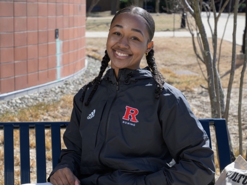 Student sitting on bench smiling